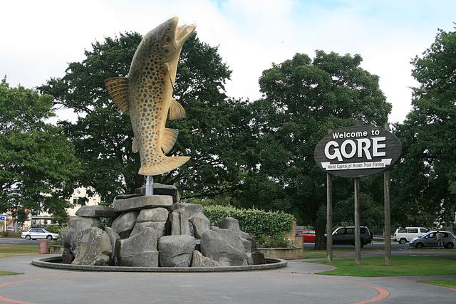 The giant brown trout statue and 'Welcome to Gore' sign in Gore.