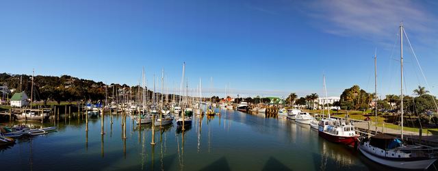 Panorama of yachts moored at the Whangārei Town Basin marina on a clear day.