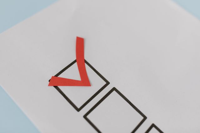 A red tick in the first of a row of empty check boxes on a white sheet of paper.